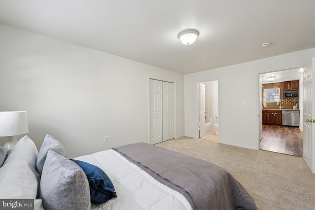 bedroom featuring light carpet, connected bathroom, and a closet