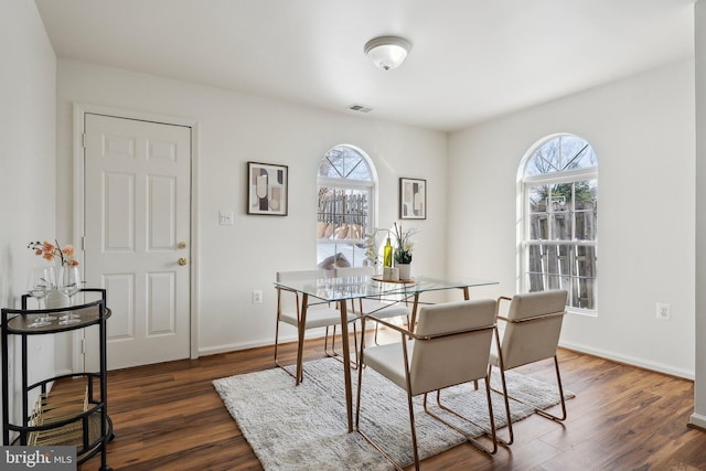 dining area with dark hardwood / wood-style flooring