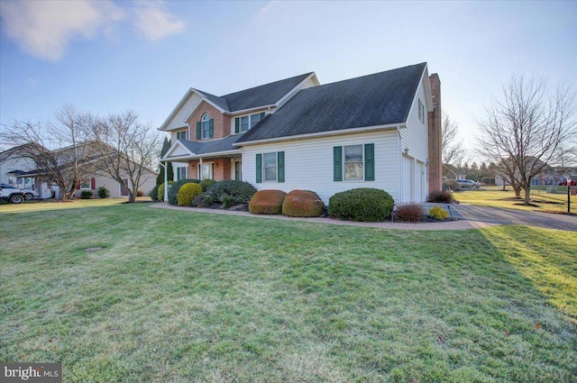 view of front facade featuring a front lawn and a garage