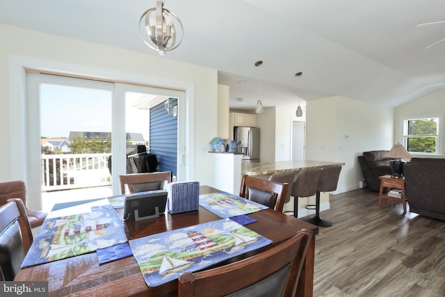 dining space featuring dark hardwood / wood-style floors and lofted ceiling