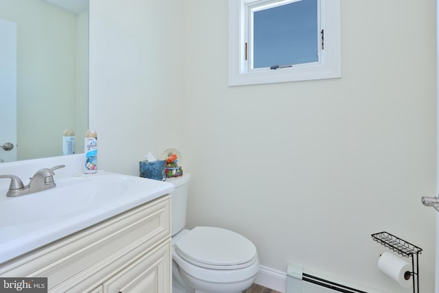 bathroom featuring vanity, toilet, and baseboard heating