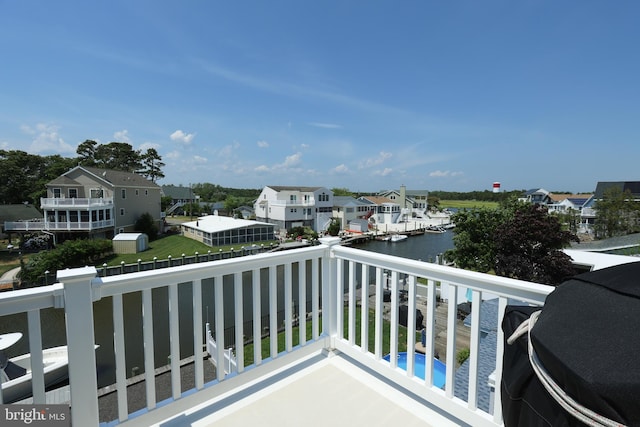 balcony with a water view and grilling area