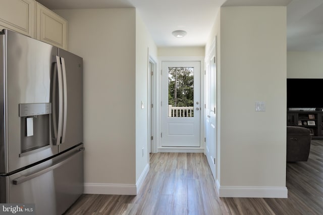 kitchen with hardwood / wood-style flooring and stainless steel refrigerator with ice dispenser