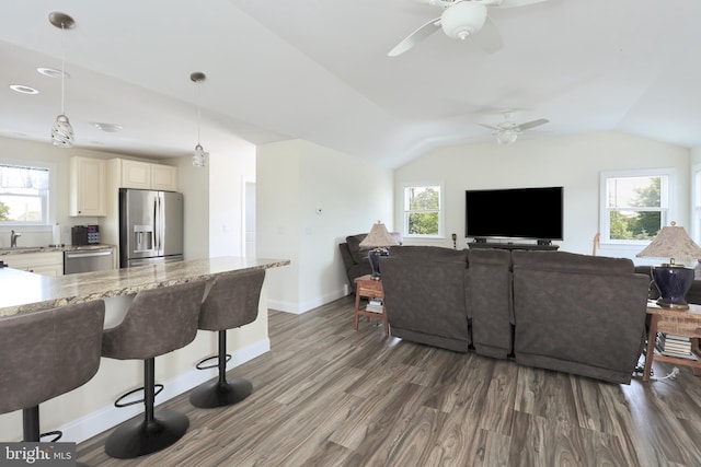 living room with dark hardwood / wood-style flooring, ceiling fan, lofted ceiling, and sink