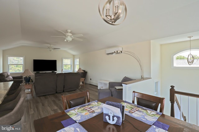 dining space with plenty of natural light, a wall mounted air conditioner, dark wood-type flooring, and vaulted ceiling