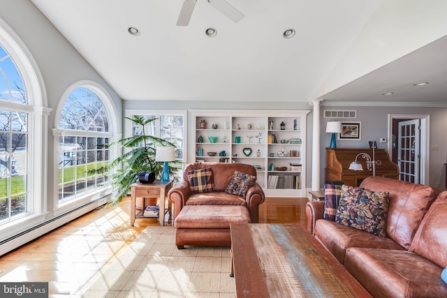 living room featuring ceiling fan, a baseboard radiator, built in features, vaulted ceiling, and light wood-type flooring