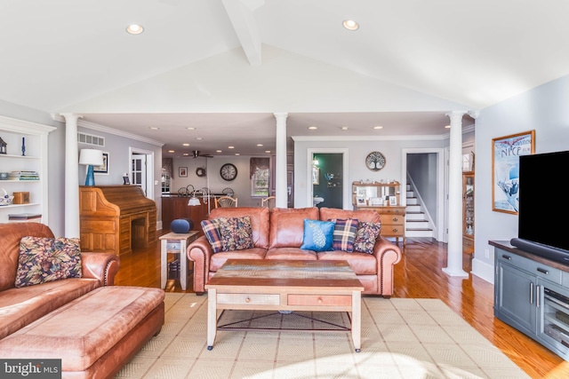 living room with lofted ceiling with beams, built in shelves, ornamental molding, light hardwood / wood-style floors, and decorative columns