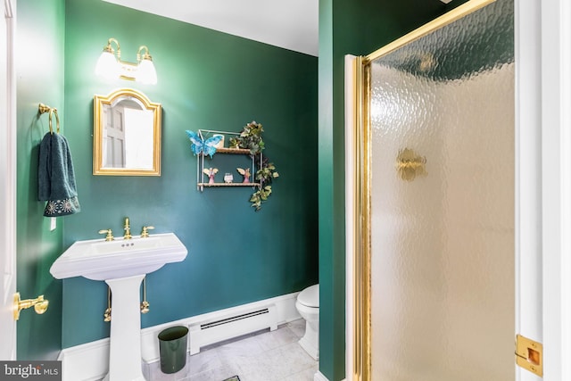 bathroom featuring tile patterned floors, toilet, a shower with door, and baseboard heating