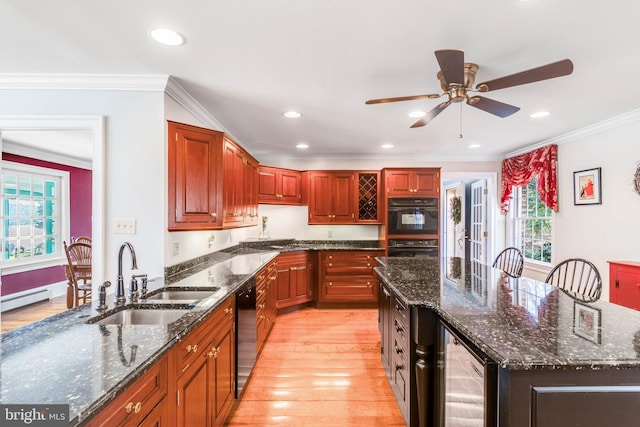 kitchen with beverage cooler, crown molding, sink, dark stone countertops, and a center island