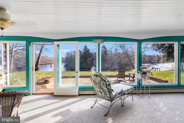 unfurnished sunroom featuring a water view