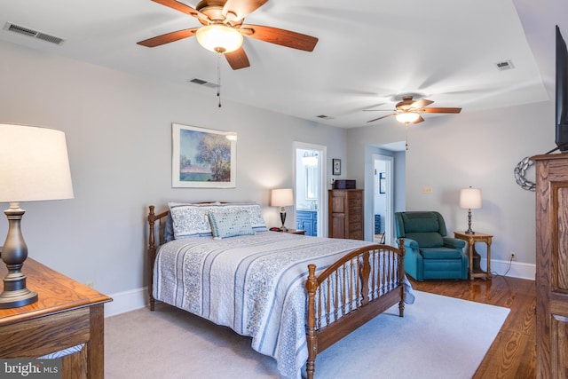 bedroom with hardwood / wood-style floors and ceiling fan