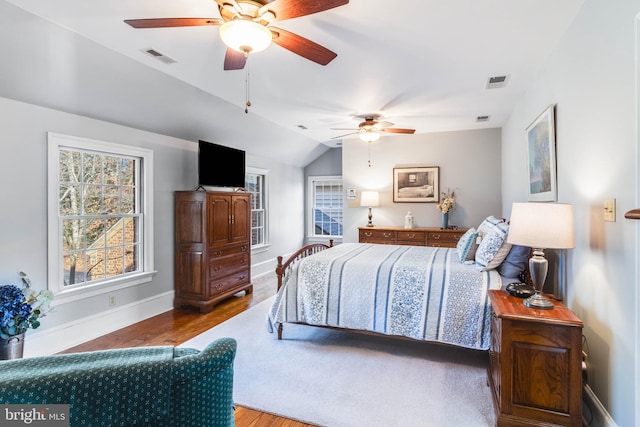 bedroom featuring hardwood / wood-style flooring, ceiling fan, and lofted ceiling