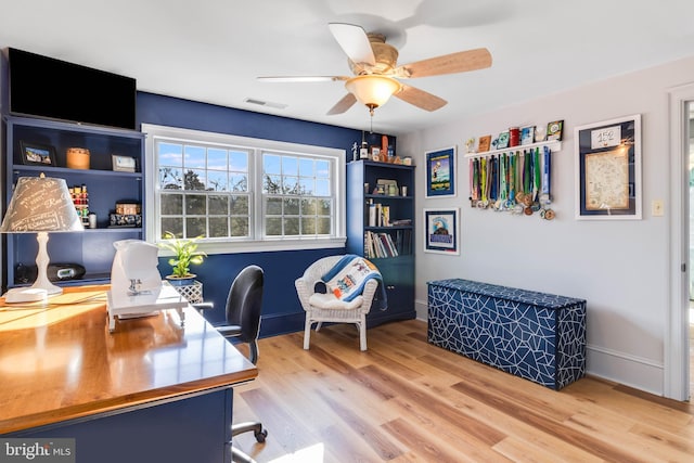 home office featuring ceiling fan and light hardwood / wood-style floors