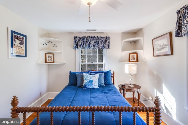 bedroom with hardwood / wood-style floors and ceiling fan