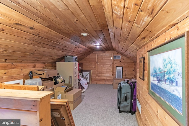 interior space featuring wood walls, light colored carpet, wooden ceiling, and vaulted ceiling