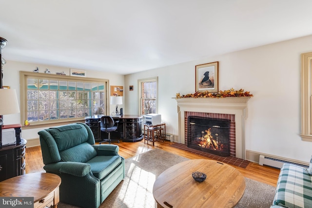 living room featuring hardwood / wood-style floors, a fireplace, and a baseboard radiator