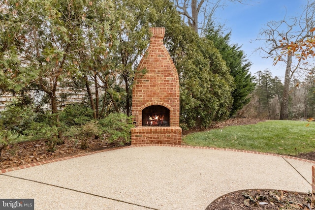 view of patio with an outdoor brick fireplace