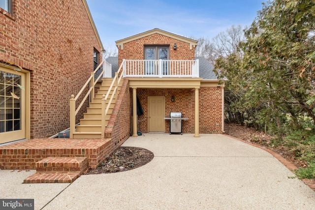 exterior space with a balcony and a patio