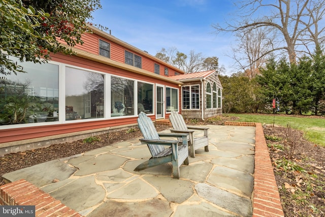 view of patio / terrace featuring a sunroom