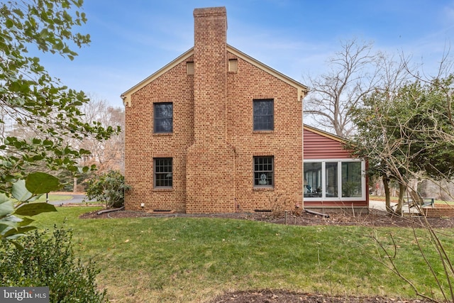 view of side of property with a yard