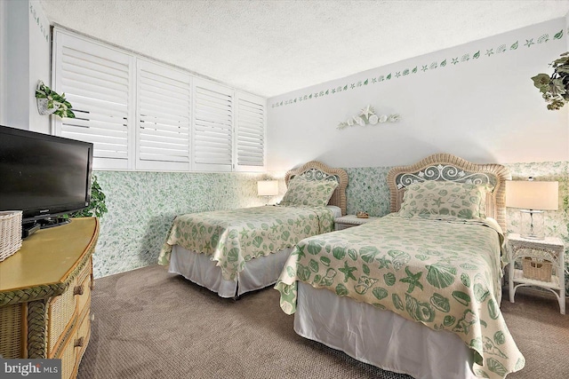 bedroom featuring a textured ceiling and carpet