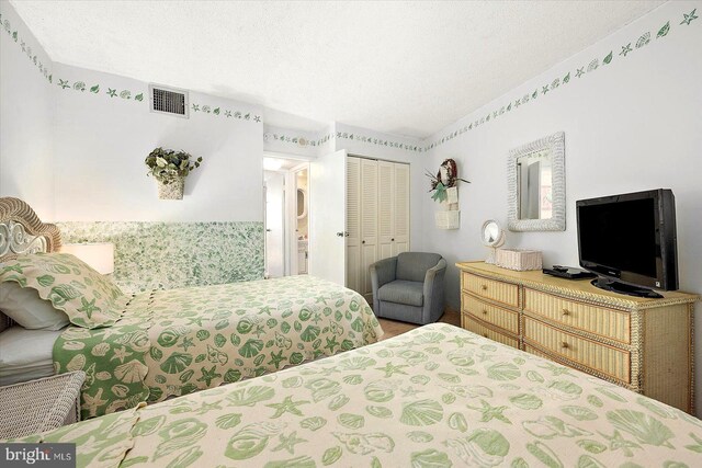 bedroom featuring a closet and a textured ceiling