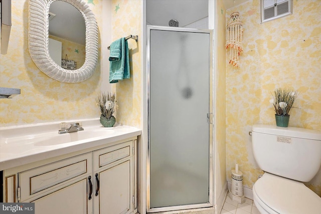 bathroom featuring toilet, tile patterned floors, walk in shower, and vanity