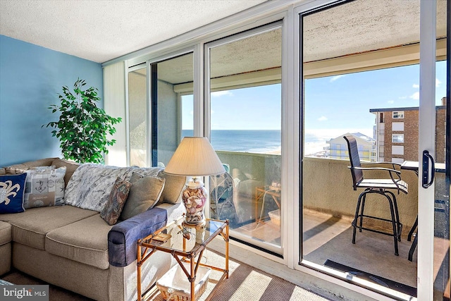 living room featuring a textured ceiling and a water view