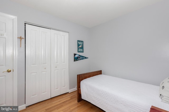 bedroom featuring light wood-type flooring and a closet