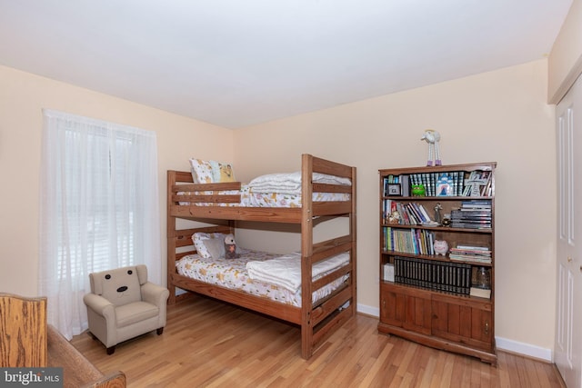 bedroom featuring baseboards and wood finished floors