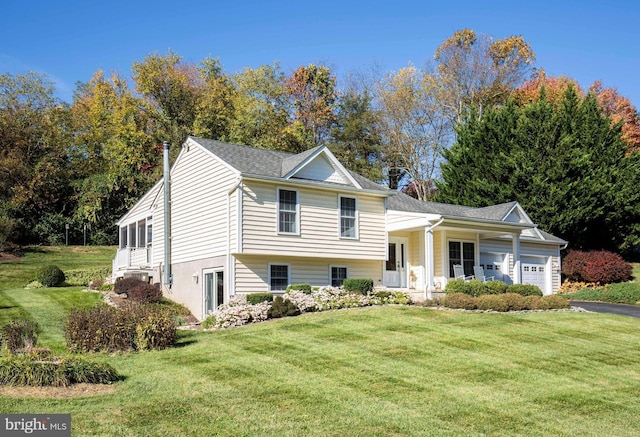 tri-level home featuring an attached garage and a front lawn