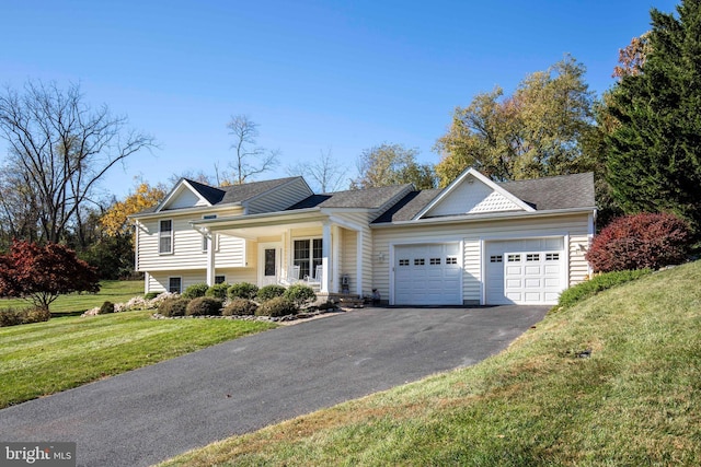 split level home featuring aphalt driveway, an attached garage, and a front lawn