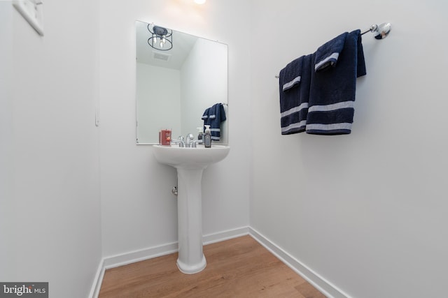 bathroom with hardwood / wood-style floors