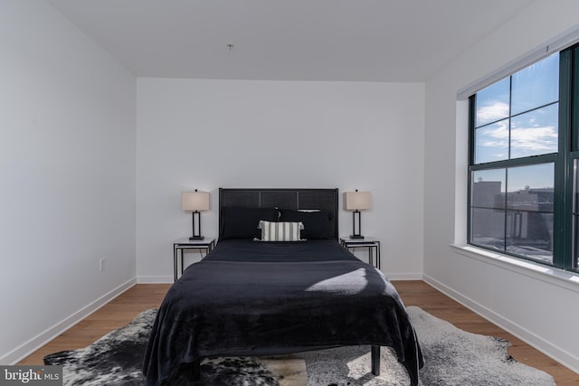 bedroom with dark hardwood / wood-style flooring