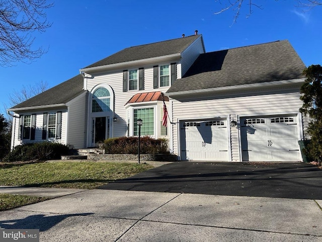 view of front facade with a front yard and a garage