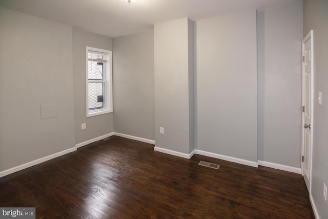 spare room featuring dark hardwood / wood-style floors