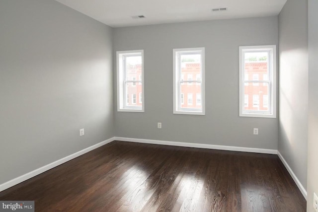 empty room featuring dark hardwood / wood-style flooring