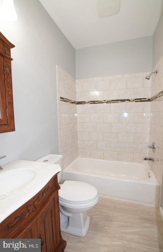 full bathroom with vanity, toilet, and tiled shower / bath