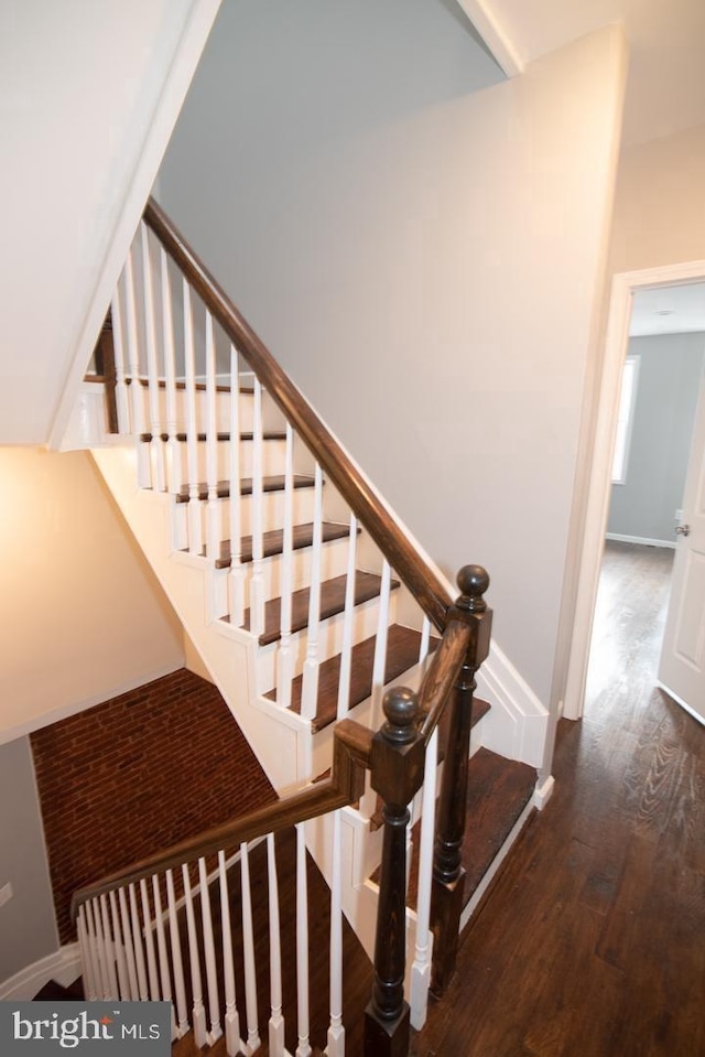 stairs with hardwood / wood-style flooring