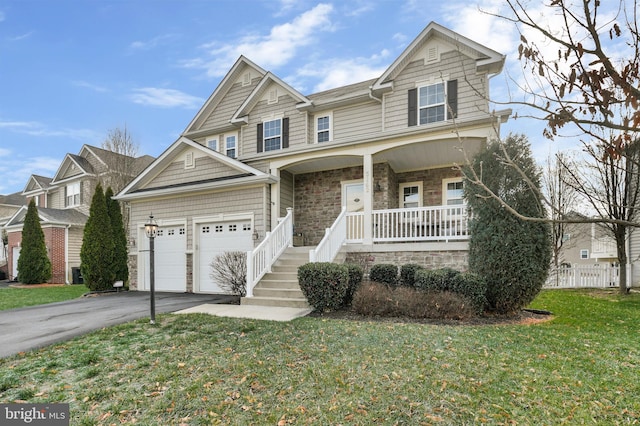 craftsman-style house featuring a front lawn and covered porch