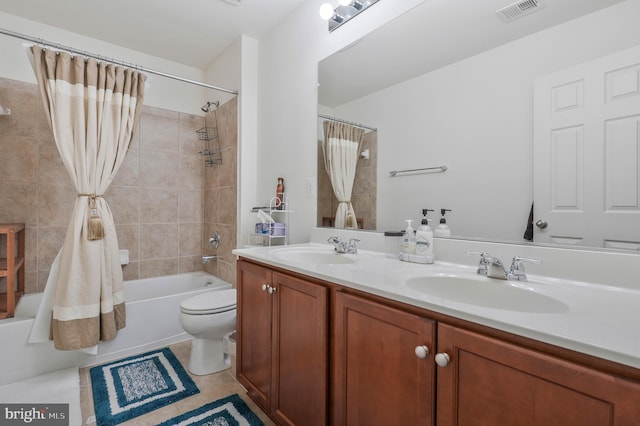 full bathroom featuring tile patterned floors, shower / bath combination with curtain, toilet, and vanity