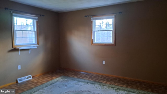 empty room with parquet flooring