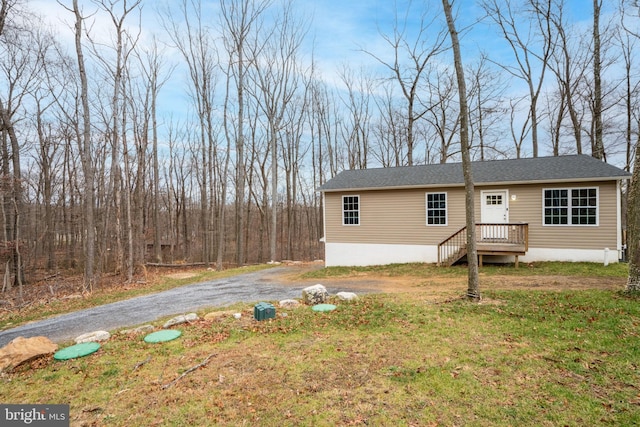 rear view of property featuring a yard