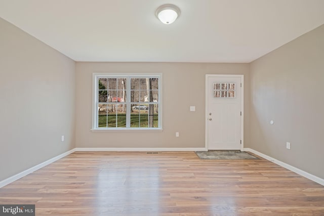 foyer entrance with light hardwood / wood-style floors