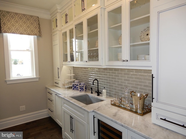 bar featuring white cabinetry, sink, dark wood-type flooring, tasteful backsplash, and light stone counters