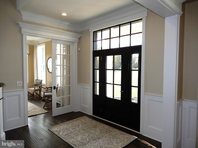 foyer featuring dark wood-type flooring and ornamental molding