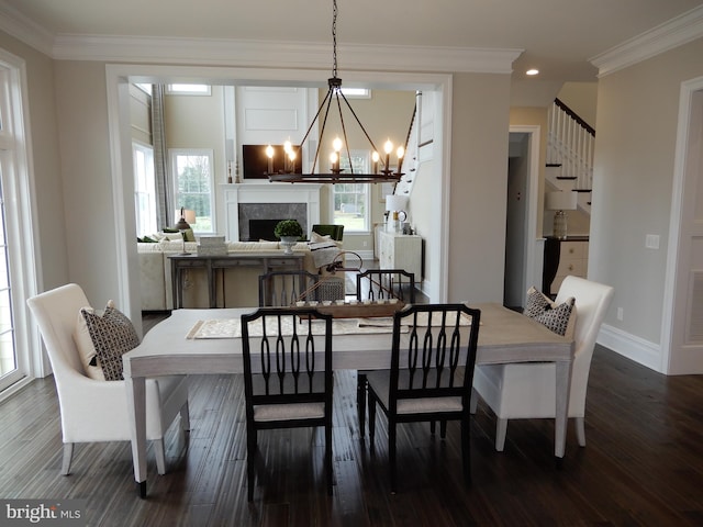 dining area featuring a healthy amount of sunlight, dark hardwood / wood-style floors, and crown molding