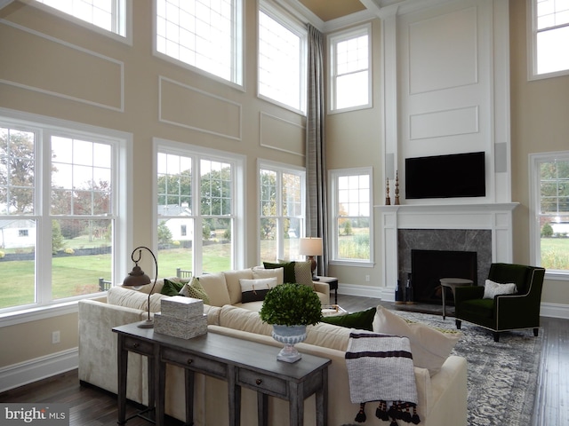 sunroom with a tiled fireplace