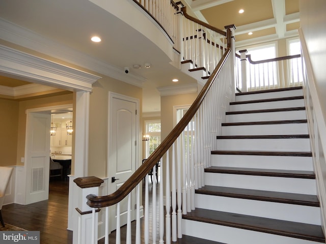 staircase featuring wood-type flooring and crown molding