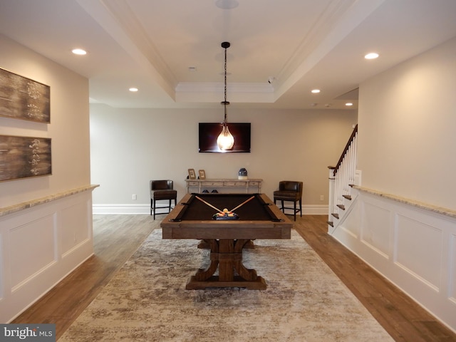 playroom featuring dark hardwood / wood-style flooring, a raised ceiling, ornamental molding, and pool table